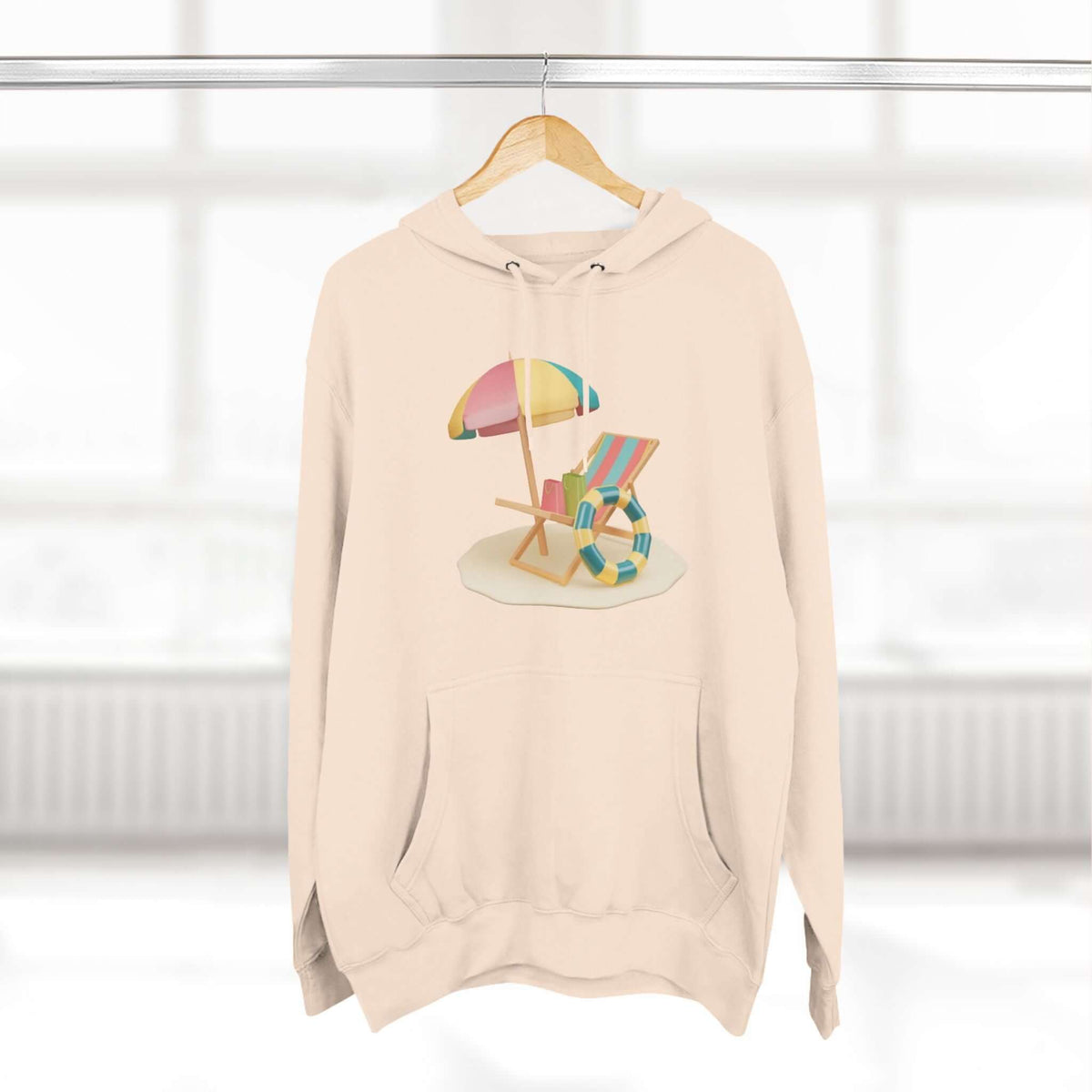 Cozy beige hoodie featuring a colorful beach chair and umbrella design, perfect for relaxed style and comfort.