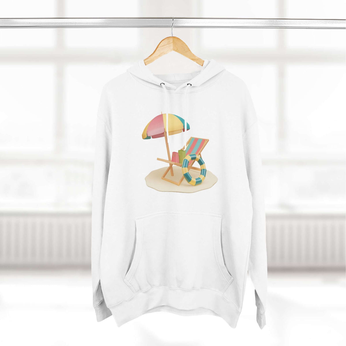 White hoodie featuring a vibrant beach chair and umbrella design, perfect for a relaxed, sunny day look.