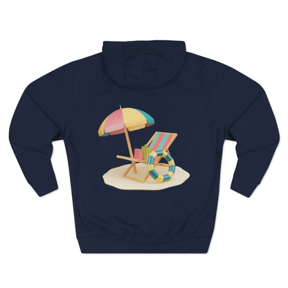 Sunny Resort Hoodie featuring a beach scene with a colorful umbrella and lounge chair on a sandy background.