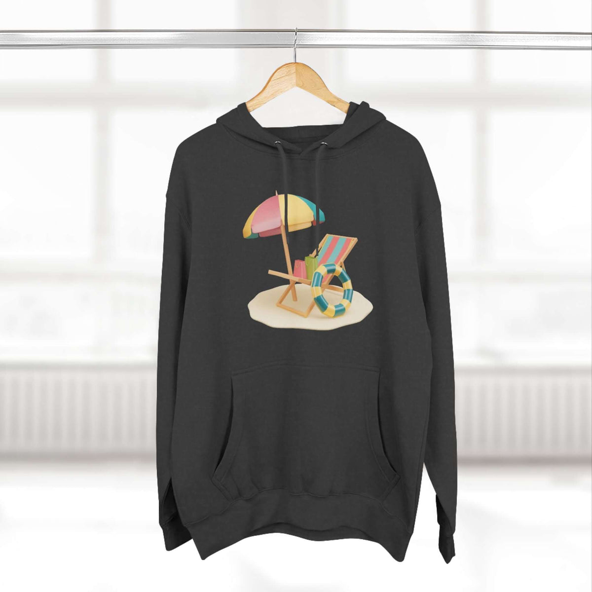 Black hoodie featuring a colorful beach scene with an umbrella and lounge chair, perfect for casual wear.