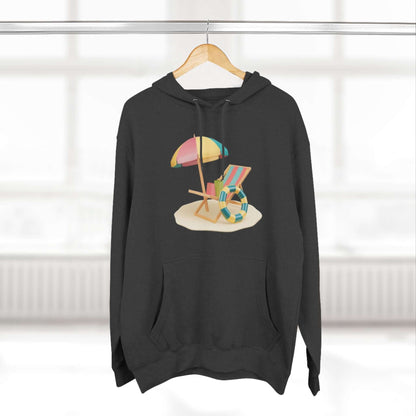 Black hoodie featuring a colorful beach scene with an umbrella and lounge chair, perfect for casual wear.