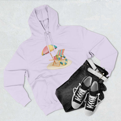 Light purple hoodie featuring a beach chair and umbrella graphic, paired with stylish denim and sneakers.