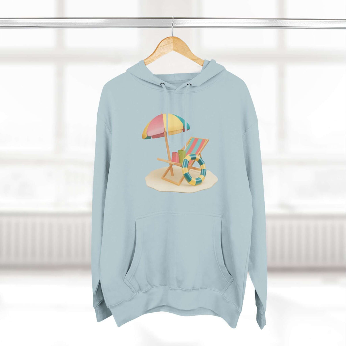 Relaxed blue Sunny Resort Hoodie featuring beach scene design with umbrella and chairs, perfect for cozy lounging.