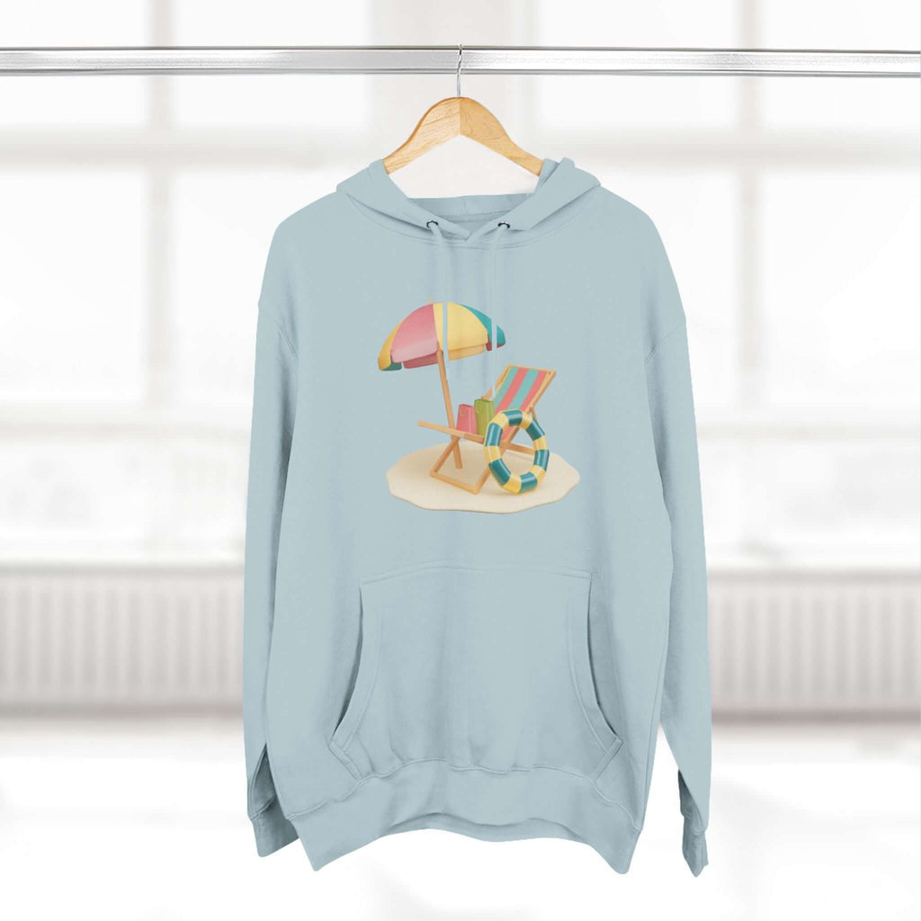 Relaxed blue Sunny Resort Hoodie featuring beach scene design with umbrella and chairs, perfect for cozy lounging.