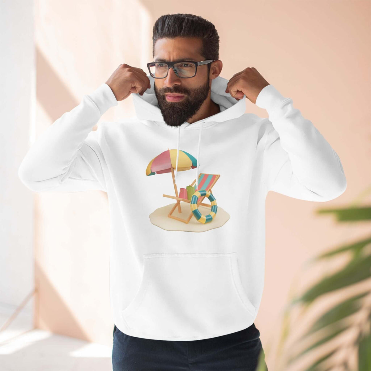 Man wearing a white Sunny Resort Hoodie featuring a beach chair and umbrella design, perfect for a relaxed, stylish look.