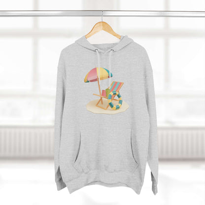 Cozy gray hoodie featuring a beach scene with a colorful umbrella and chair, perfect for relaxed beach vibes.